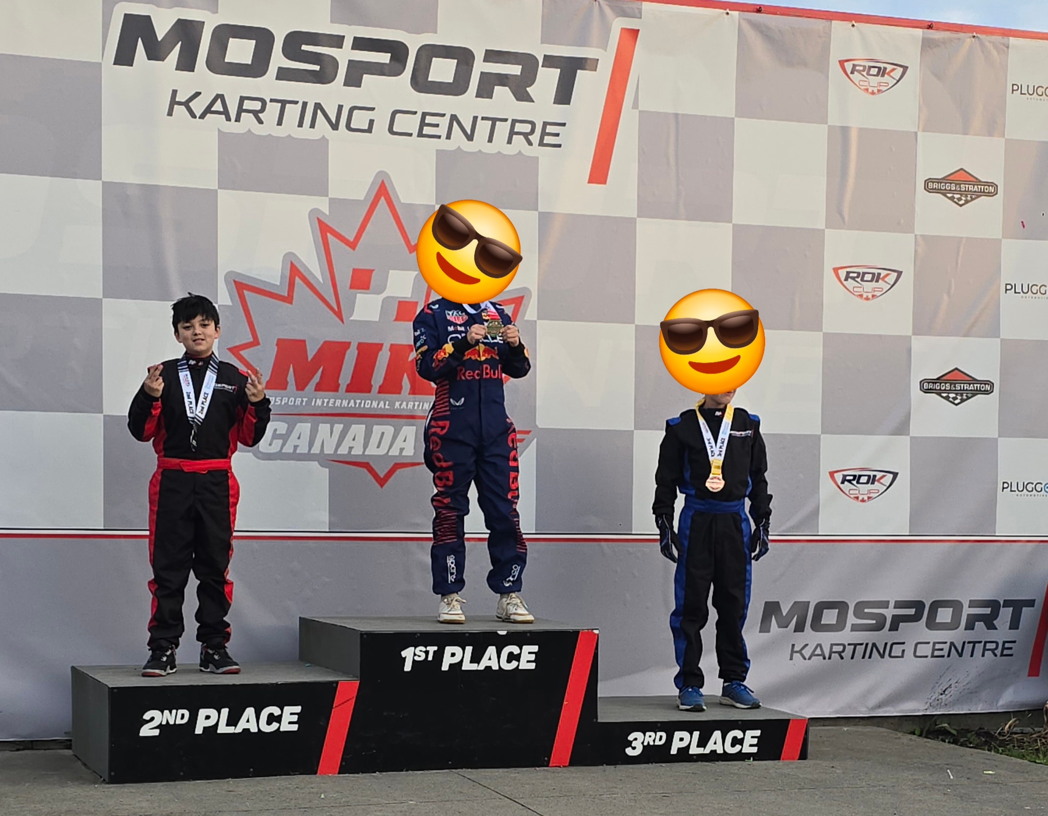Young kart racers on podium with medals