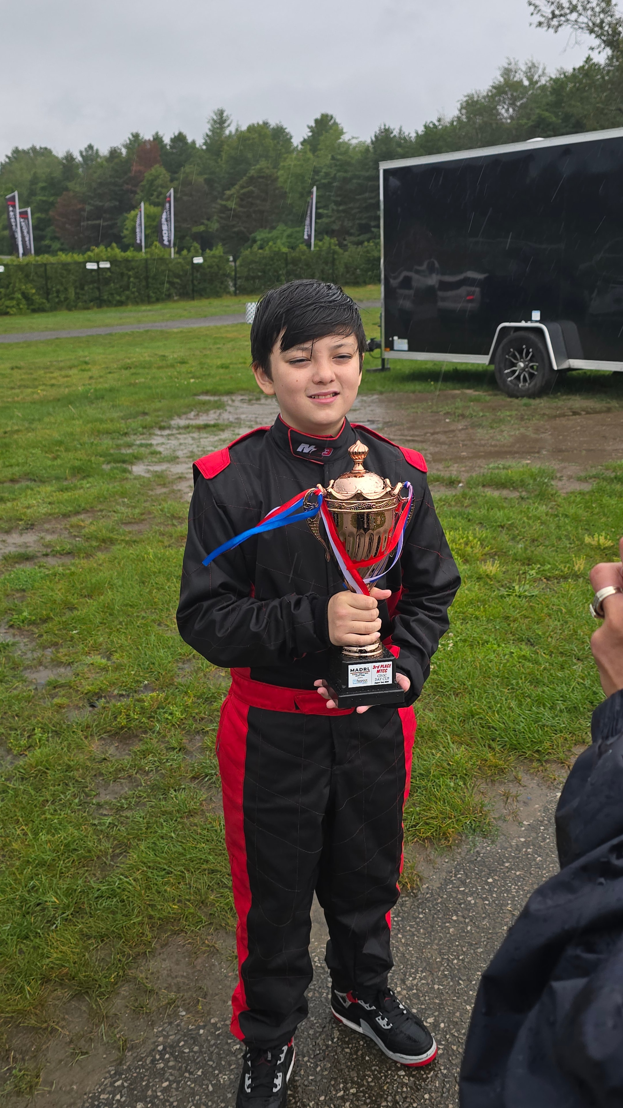Carter holding Bronze Cup trophy in the rain